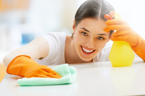 Carpet cleaning technician preparing equipment in a safe working area